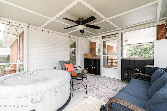 sunroom featuring coffered ceiling and ceiling fan