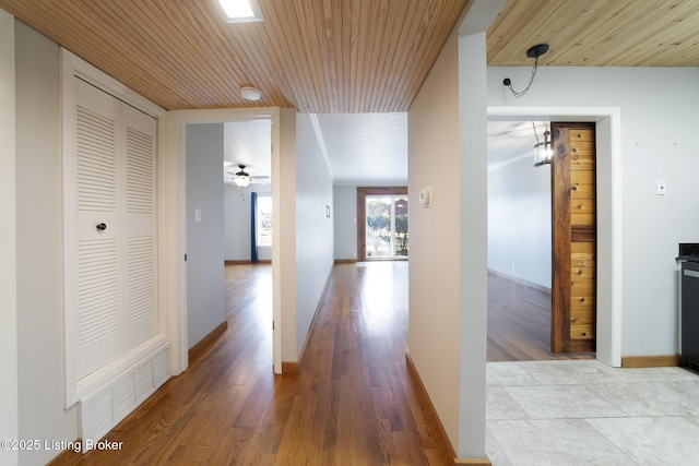 hall featuring wooden ceiling and light wood-type flooring