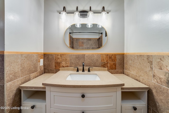 bathroom featuring vanity and tile walls