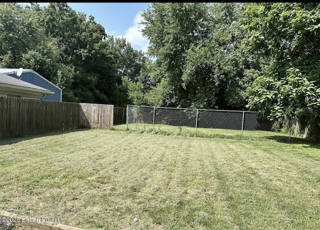 view of yard with a fenced backyard