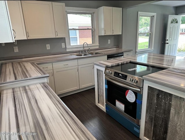 kitchen with dishwashing machine, dark wood-style flooring, a sink, white cabinetry, and stainless steel range with electric cooktop