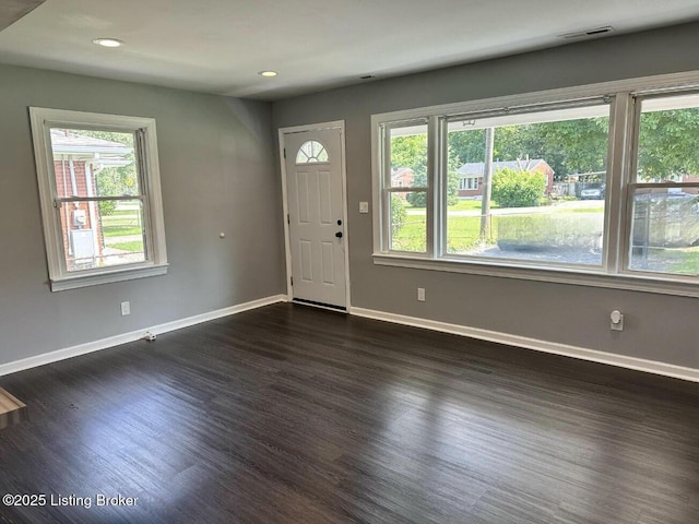 foyer with dark wood-style floors, visible vents, baseboards, and recessed lighting