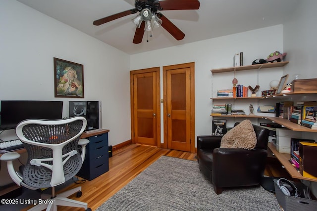 home office featuring ceiling fan and light hardwood / wood-style floors