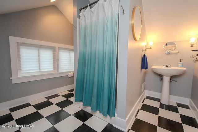 bathroom featuring lofted ceiling