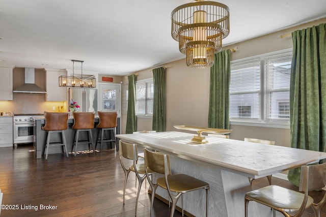 dining space featuring an inviting chandelier and dark hardwood / wood-style flooring