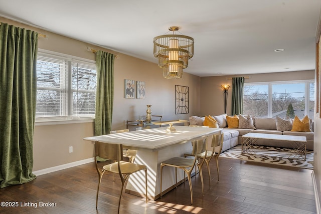 dining space featuring dark hardwood / wood-style flooring and a chandelier