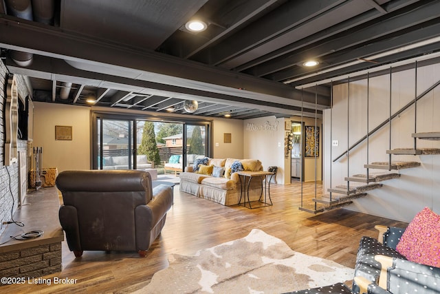 living room with beam ceiling and wood-type flooring