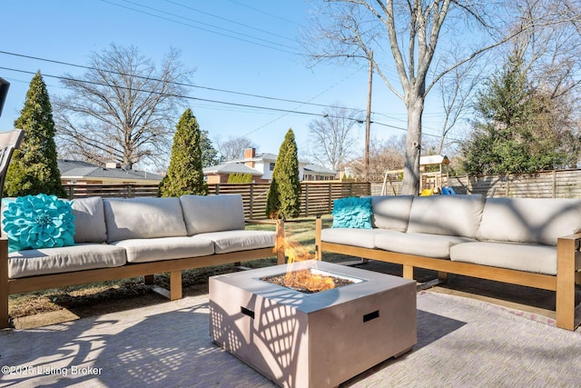 view of patio / terrace featuring an outdoor living space with a fire pit and a playground