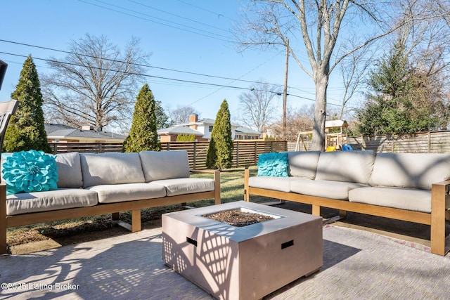 view of patio / terrace with a playground and an outdoor living space with a fire pit