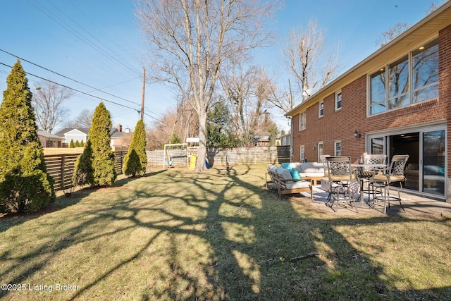 view of yard featuring a playground, an outdoor living space, and a patio area