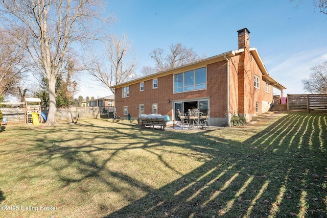 back of property with a playground and a yard