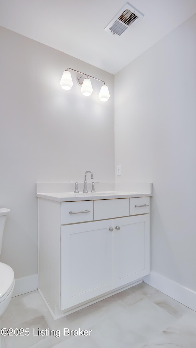 bathroom featuring vanity and toilet