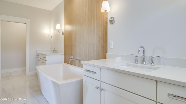 bathroom with a tub to relax in and vanity