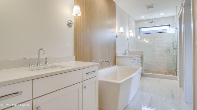 bathroom featuring vanity and separate shower and tub