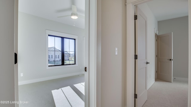 corridor featuring light colored carpet