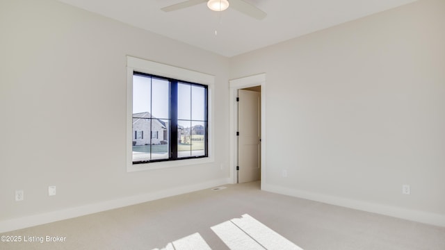 empty room with light colored carpet and ceiling fan