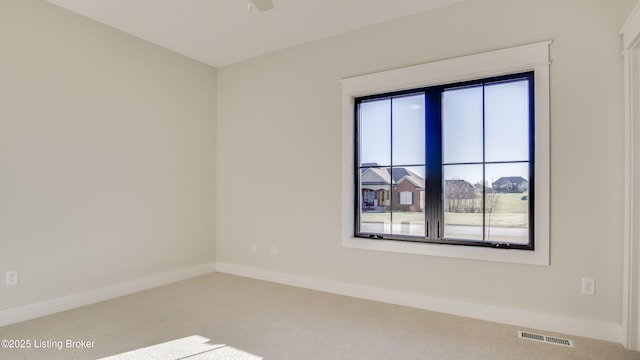 carpeted spare room with ceiling fan