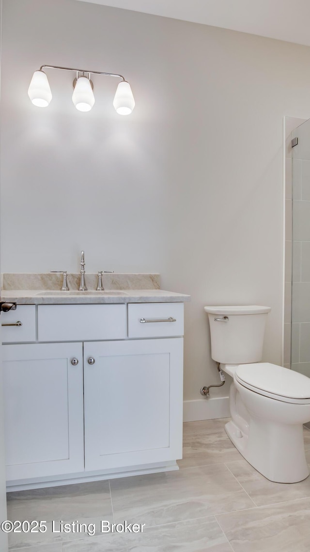 bathroom featuring vanity, toilet, and a shower