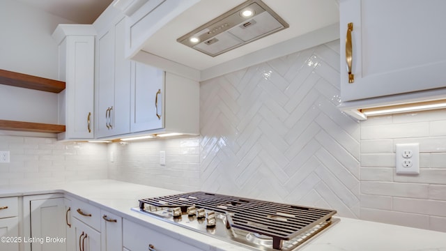 kitchen featuring white cabinetry, light stone counters, and decorative backsplash