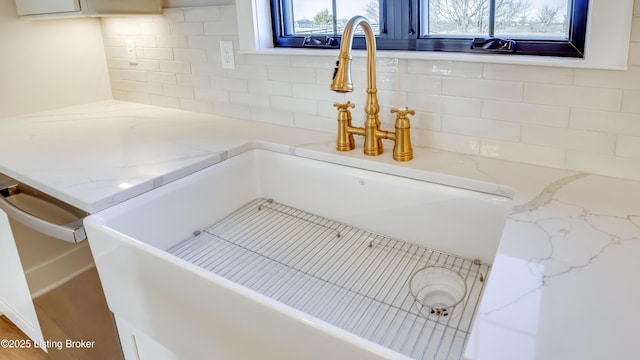 interior space featuring sink and light stone counters