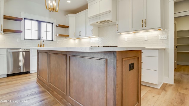 kitchen featuring white cabinetry, decorative light fixtures, light hardwood / wood-style flooring, dishwasher, and a kitchen island