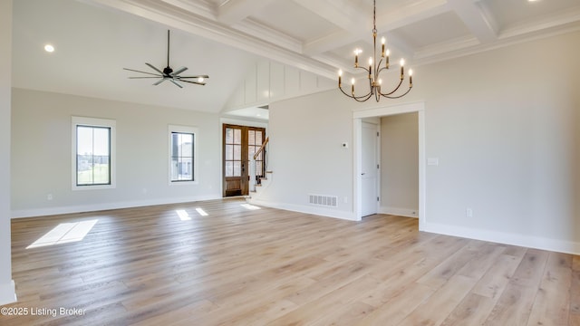 unfurnished room featuring ceiling fan with notable chandelier, coffered ceiling, beam ceiling, and light hardwood / wood-style floors