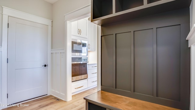 mudroom with light hardwood / wood-style flooring