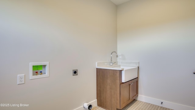 washroom with sink, cabinets, hookup for a washing machine, and hookup for an electric dryer