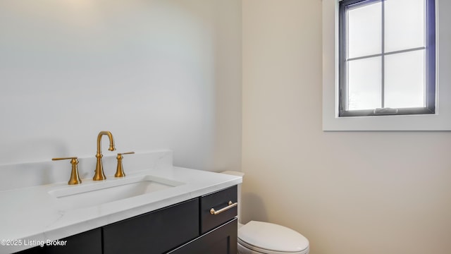 bathroom featuring vanity and toilet