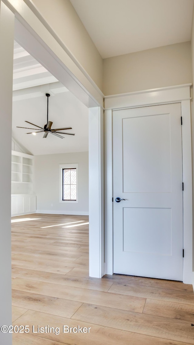 foyer entrance with lofted ceiling with beams, ceiling fan, and light wood-type flooring