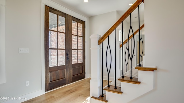 foyer featuring french doors and light hardwood / wood-style floors