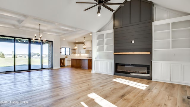 unfurnished living room featuring coffered ceiling, high vaulted ceiling, light hardwood / wood-style flooring, beam ceiling, and ceiling fan with notable chandelier