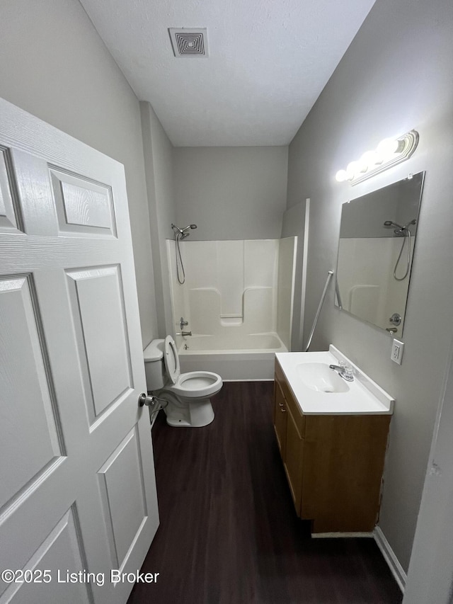 full bathroom with bathtub / shower combination, vanity, toilet, and hardwood / wood-style flooring