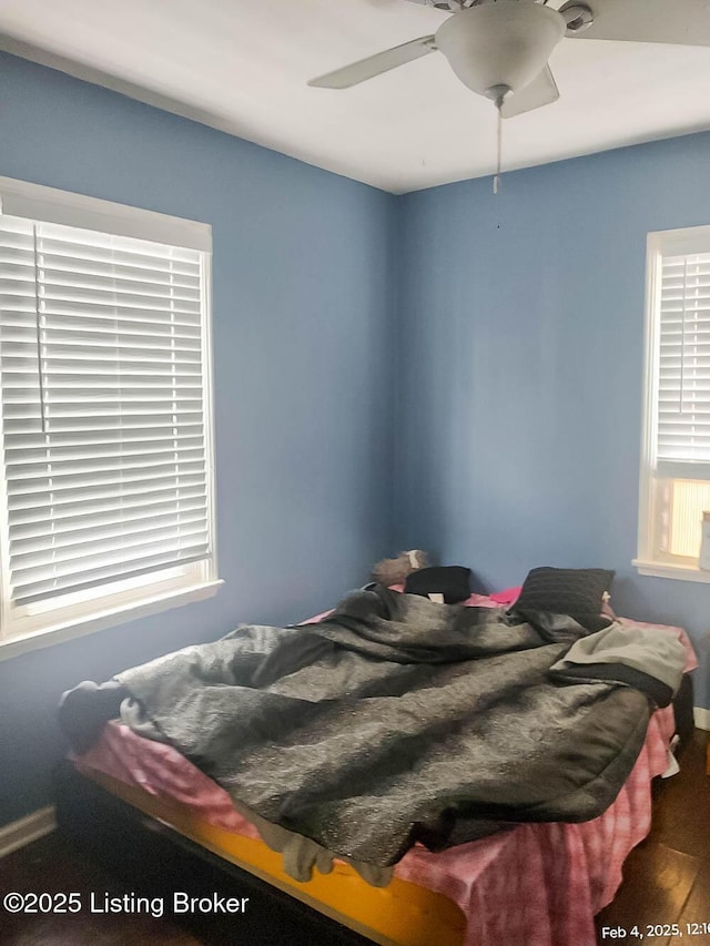 bedroom with ceiling fan and wood-type flooring