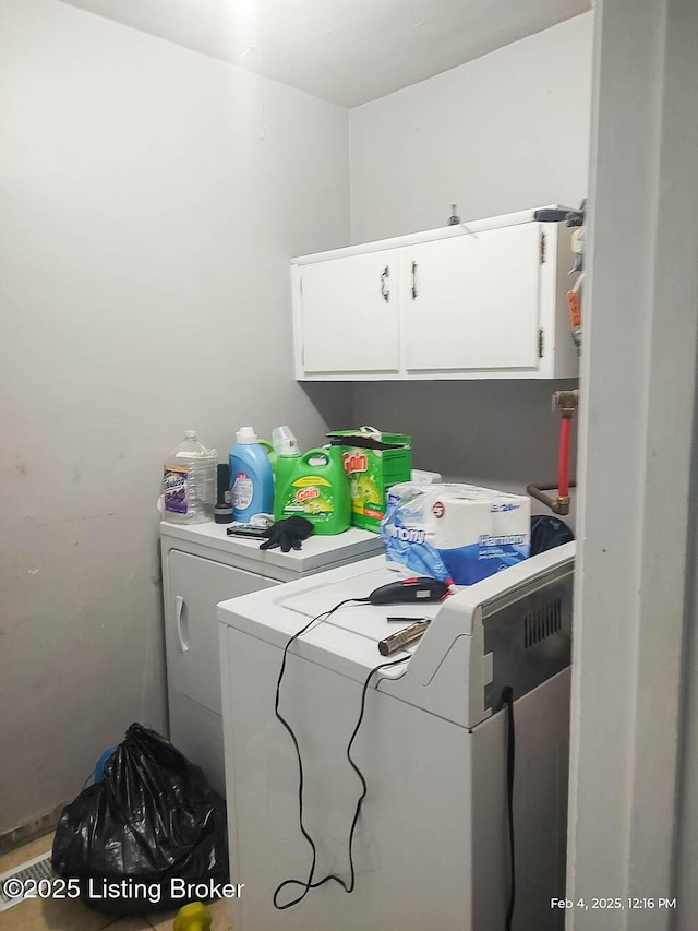 laundry room featuring cabinets and separate washer and dryer