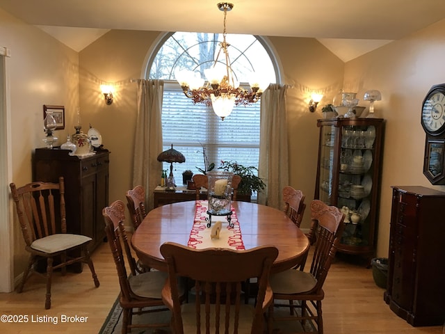 dining area with a chandelier and light wood-type flooring