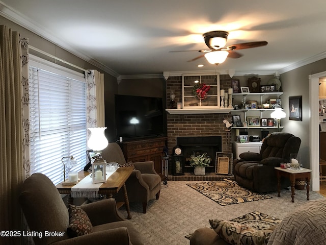 living room featuring crown molding, ceiling fan, and a fireplace