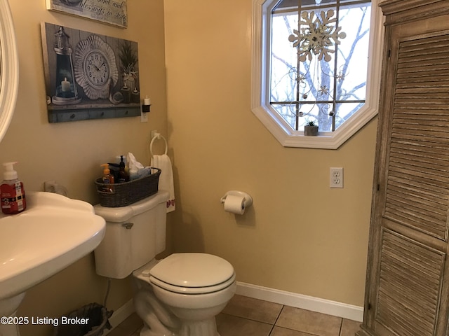 bathroom with tile patterned floors and toilet