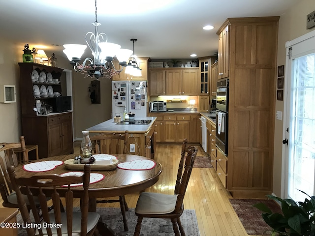 dining space featuring a chandelier and light wood-type flooring