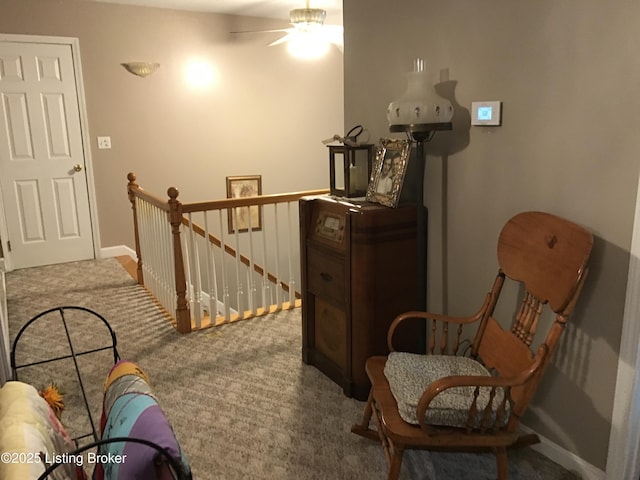 living area with ceiling fan and carpet floors