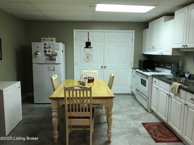 kitchen featuring white cabinetry, white appliances, a paneled ceiling, and sink