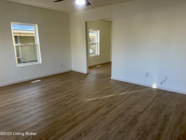 unfurnished room featuring ceiling fan and dark hardwood / wood-style flooring