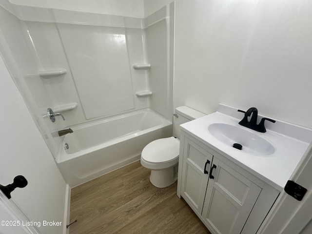 full bathroom featuring vanity, hardwood / wood-style flooring, shower / bathtub combination, and toilet