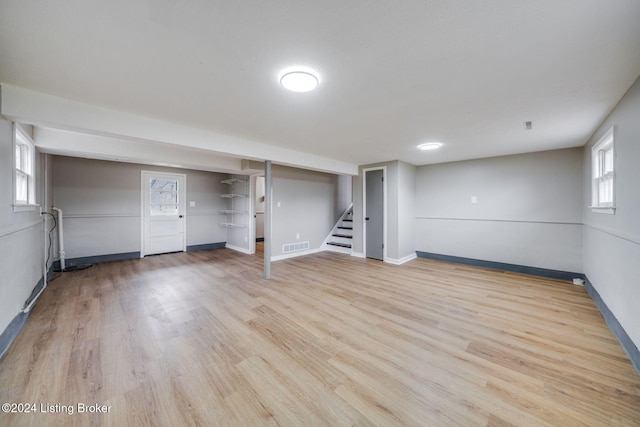 basement with light hardwood / wood-style floors