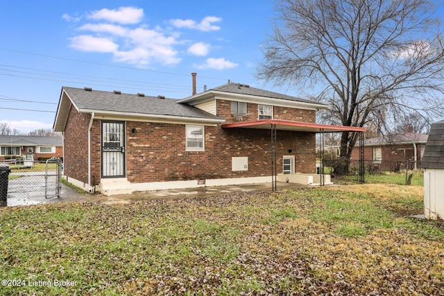 rear view of property featuring a patio and a lawn