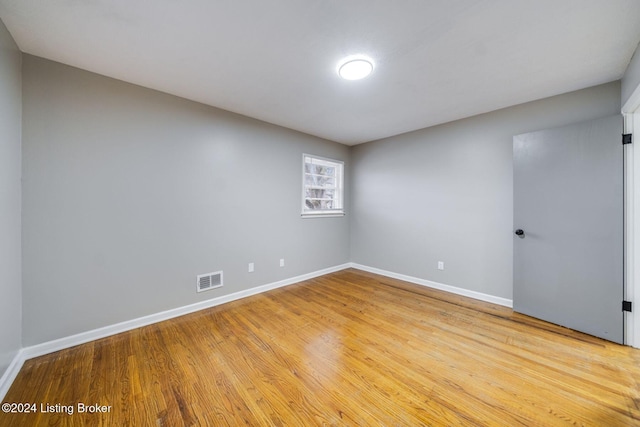 unfurnished room with light wood-type flooring