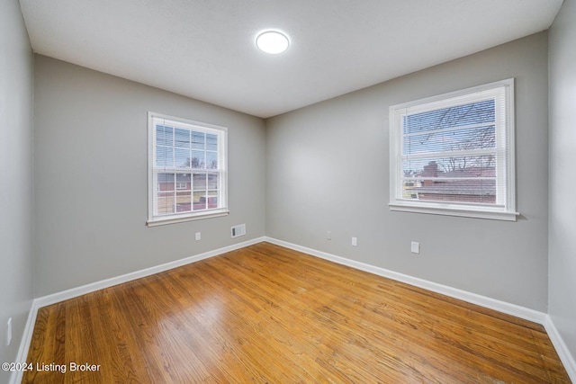 spare room featuring light hardwood / wood-style floors