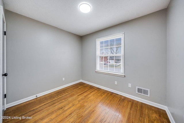 empty room featuring wood-type flooring