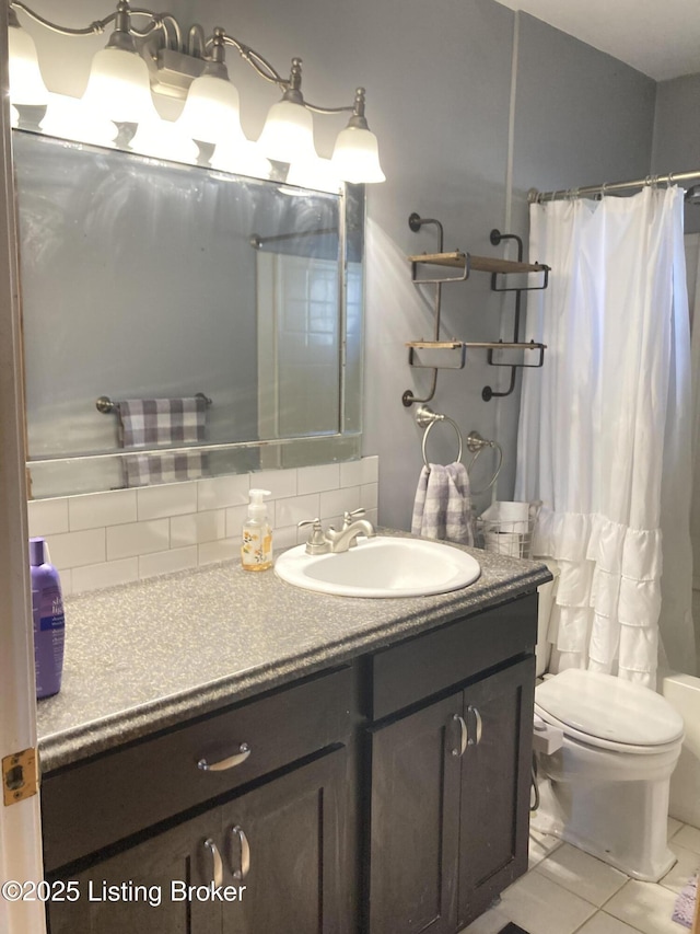 full bathroom with tile patterned flooring, tasteful backsplash, vanity, toilet, and shower / bath combo with shower curtain