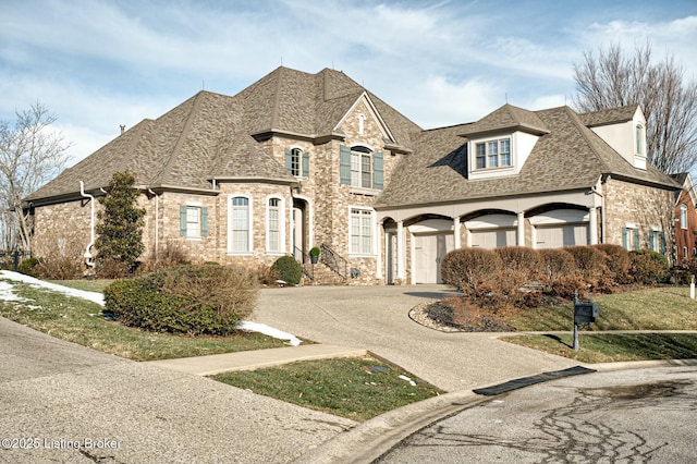 french provincial home with driveway and roof with shingles